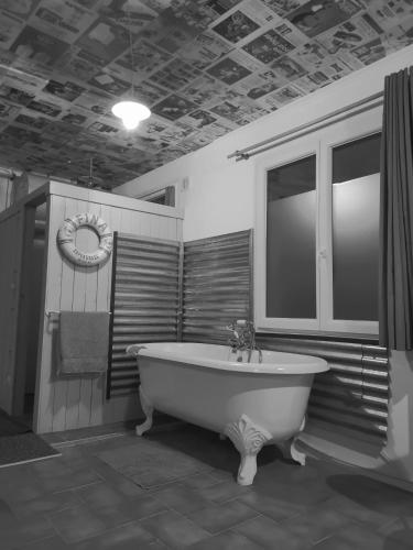 a large bathroom with a tub and a window at Augrenierdelachaumine in Précy-sur-Oise