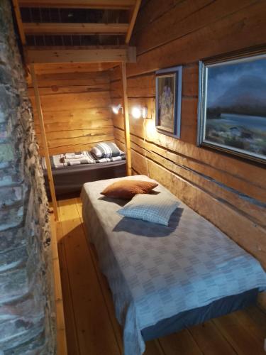 a bedroom with a bed in a wooden cabin at Arctic house in Rovaniemi