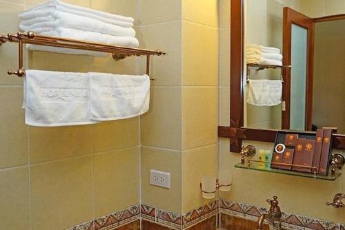 a bathroom with a sink and a mirror and towels at Hoa Binh Resort in Hòa Bình