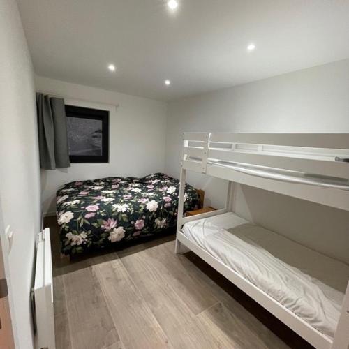 a bedroom with two bunk beds and a bed at Deep Forest in Bastogne