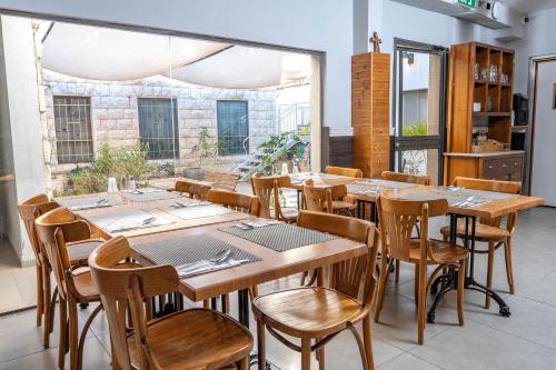a dining room with wooden tables and chairs at Villa Nazareth - Boutique hotel in a central location in Nazareth