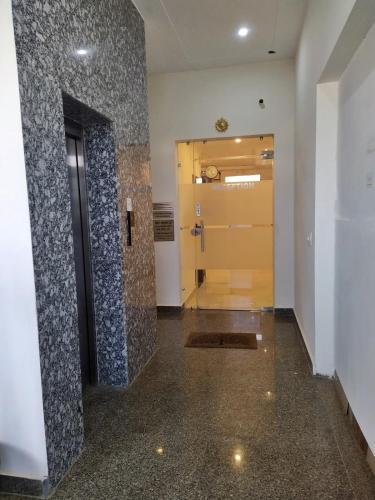 a hallway with a door and a tile wall at Hotel Sahajtam Inn in Sonīpat
