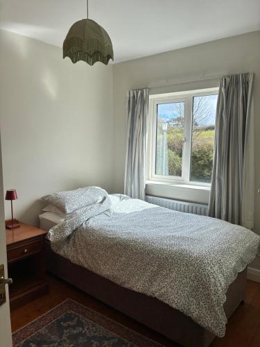 a bedroom with a bed and a window at 19 Westlands in Westport