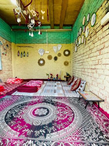 a room with a colorful rug on the floor at Mj s Home in Kalgha