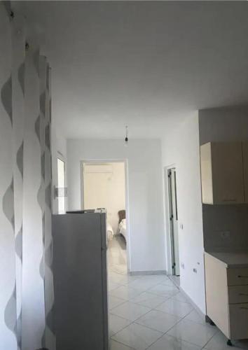a room with white walls and a room with a kitchen at Guesthouse Oasis in Baks-Rrjoll