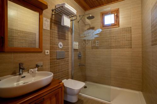 a bathroom with a shower and a sink and a toilet at Odile Hotel by Naturelife in Cıralı