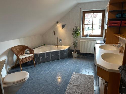 a bathroom with a tub and a toilet and a sink at Fewo Susi Allgäu in Buchloe