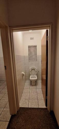 a bathroom with a toilet in a stall at HL Self-catering Accommodation in Bonnievale