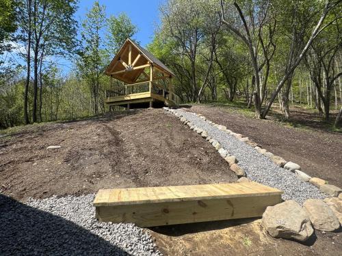 a house on top of a hill with a bench at The Old Orchard Cottage in LaFayette