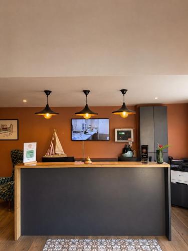 a kitchen with a counter with lights above it at La Frégate in Collioure