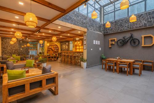 a restaurant with tables and chairs and a bike on the wall at The Social Stays Kasol in Kasol