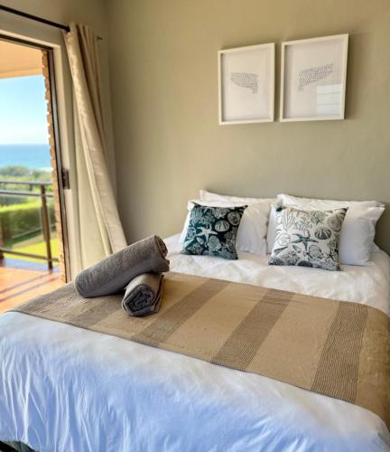 a bedroom with a bed with a view of the ocean at Kingfish Cove, Pennington in Kelso