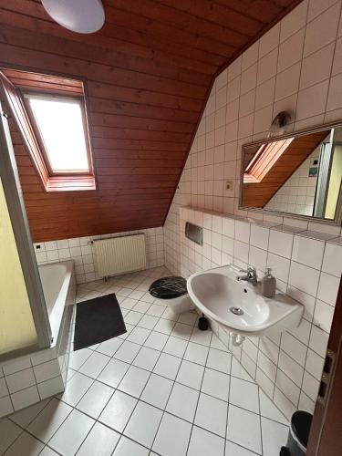 a bathroom with a sink and a bath tub at ME Apartments - Big Space in Bad Camberg