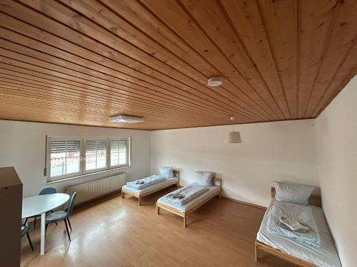 a room with two beds and a table in it at ME Apartments - Big Space in Bad Camberg