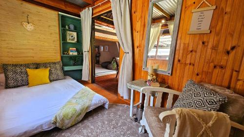 a bedroom with a bed and a chair in a room at Crabb Cottage and escape in St Lucia
