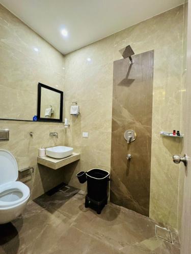 a bathroom with a toilet and a sink and a shower at Fun Square Hotel in Sangrūr