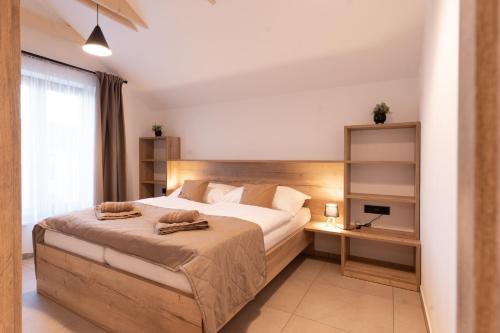 a bedroom with a large bed and a desk at Vinařství Herůfek in Zaječí