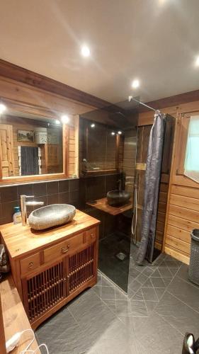 a large bathroom with a sink and a shower at Magnifique chalet , 10 personnes, vue panoramique, bain nordique in Passy