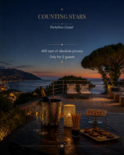 a table with a plate of food and wine glasses at Counting Stars - Private Luxury Retreat for Two in Recco