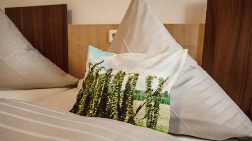 a bed with two pillows on top of it at Zum Hopfenbauer in Rudelzhausen