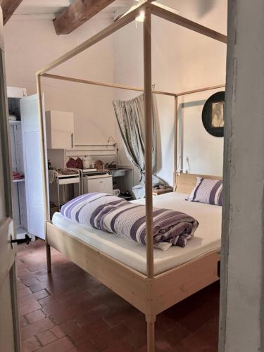 a bedroom with a canopy bed in a room at La Fratta Art - House in Marsciano