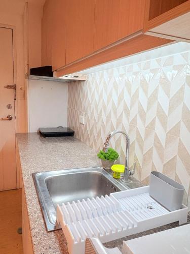 a kitchen with a sink and a counter top at Sunvida Tower Across SM Cebu CITY VIEW in Cebu City