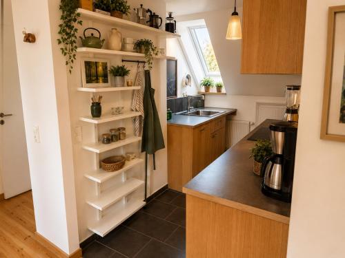 a kitchen with white shelves and a sink at Amrum Family Hideaway-Grosse Wohnung in Norddorf für bis zu 6 Personen in Norddorf