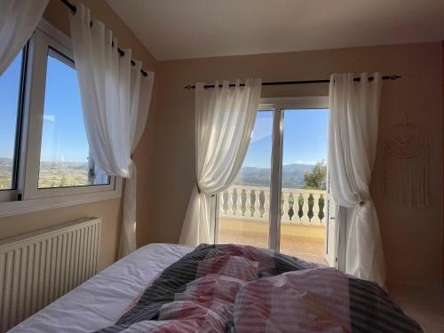 a bedroom with a bed in front of a window at Letymvou Terrace in Letimbou