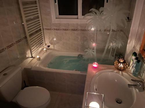 a bathroom with a tub and a toilet and a sink at Letymvou Terrace in Letimbou
