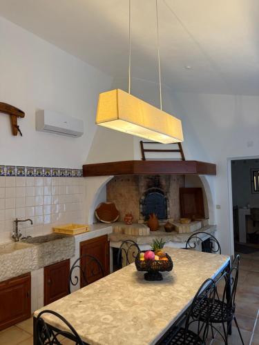 a kitchen with a table with a bowl of fruit on it at Quinta do Passal in Coimbra