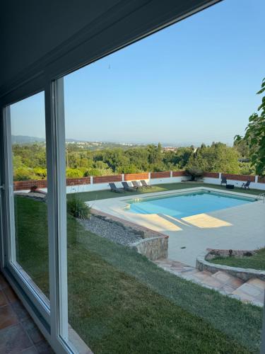 a view from a window of a swimming pool at Quinta do Passal in Coimbra
