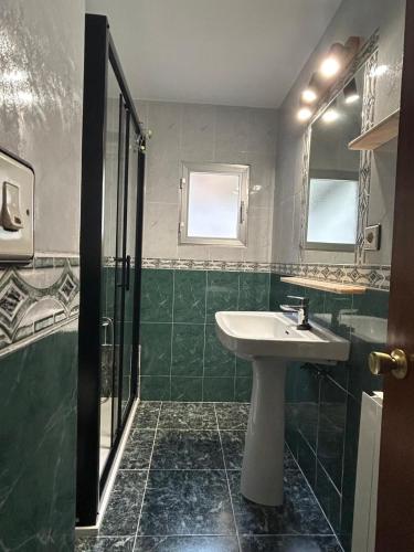 a bathroom with a sink and a shower at El Duje in Tielve