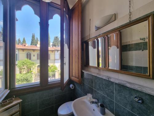 a bathroom with a sink and a mirror and windows at B&B Firenze 400 in Florence