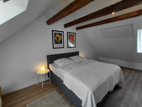 a bedroom with a bed and a table with a candle at s' Kännele Ferienwohnungen in Mudau