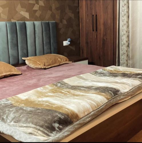 a bed with two pillows on top of it at 22nd Weekend Stays in Bhīm Tāl