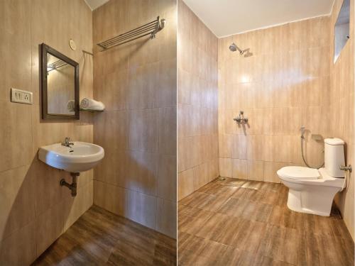 a bathroom with a toilet and a sink at Hotel Salty Waves Baga in Baga