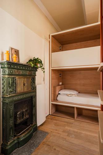 a bedroom with a fireplace and a bunk bed at CENTRAL Hostel La Rochelle Centre in La Rochelle