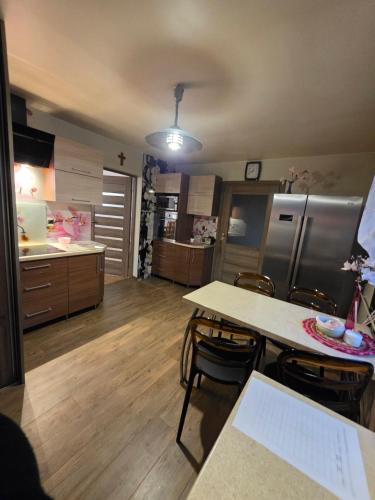 a large kitchen with a table and chairs in it at Chill House Lipowo Mazury in Lipowo