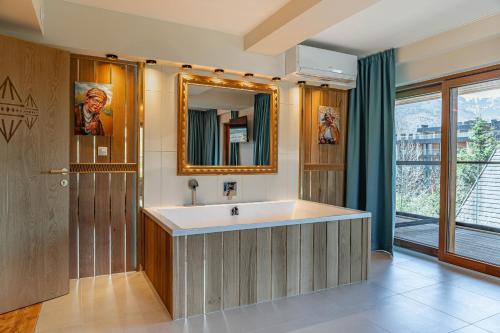 a bathroom with a sink and a mirror at Mountain Diamond Resort in Zakopane