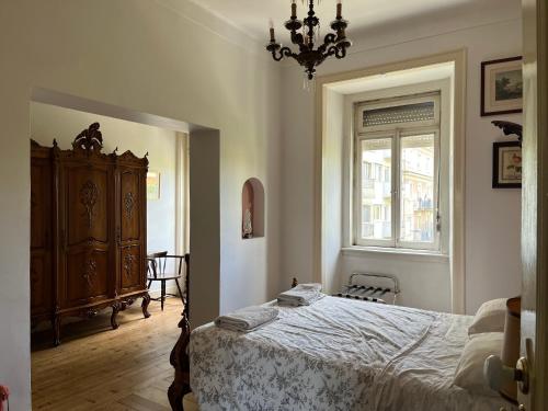 a bedroom with a bed and a dresser and a window at Family Macedo in Lisbon