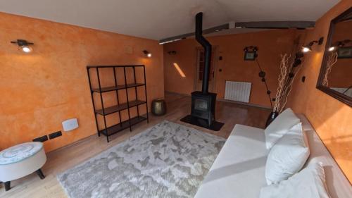 a living room with a wood stove in a room at Casa Rural BASARTE in Bakio