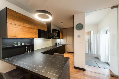 a kitchen with a large black counter top at Penzion ZENIT in Prešov