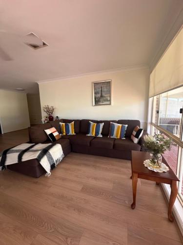 a living room with a couch and a table at Private Rm3A in Elderslie in Elderslie