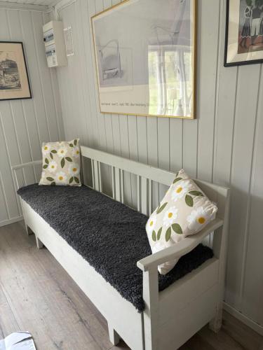 a bedroom with a crib with a pillow on it at Lillhuset Gallerud in Årjäng