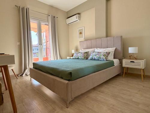 a bedroom with a large bed and a window at Delta Apartment • next to the beach in Roda