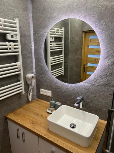 a bathroom with a sink and a mirror at Odskocznia2 in Maniowy