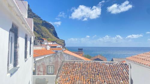 a view of the ocean from the roofs of buildings at Casa do Octavia in Corvo