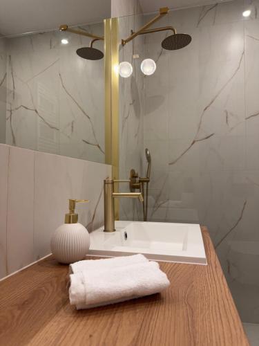a bathroom with a sink and a towel on a counter at Pino SeaView I in Gdańsk