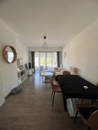 a living room with a couch and a table at Chambre d'hôte Cannes in Le Cannet