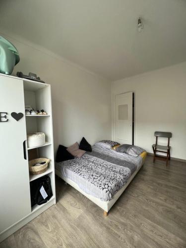 a bedroom with a bed and a book shelf at Chambre d'hôte Cannes in Le Cannet